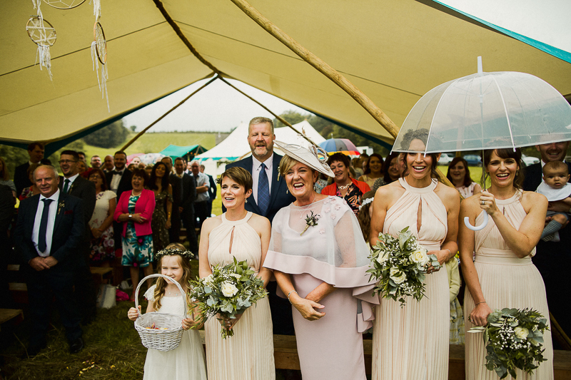 Smiling bridesmaids stand under the Wedding Awning in Shropshire, England